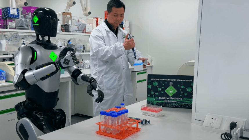 Humanoid robot working alongside a scientist at a laboratory bench