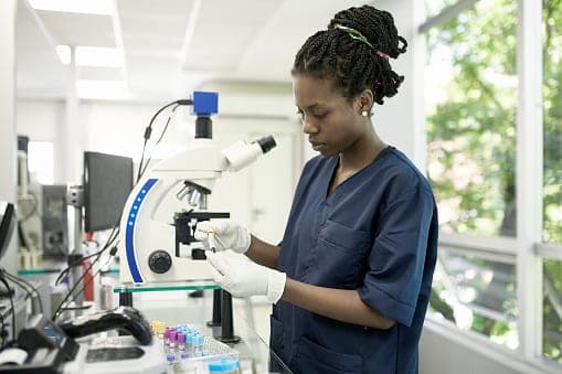 Laboratory technician working at a microscope